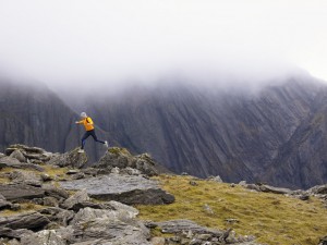 Man jumping off rock.