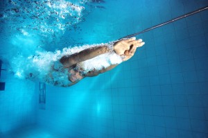 Swimmer diving into pool